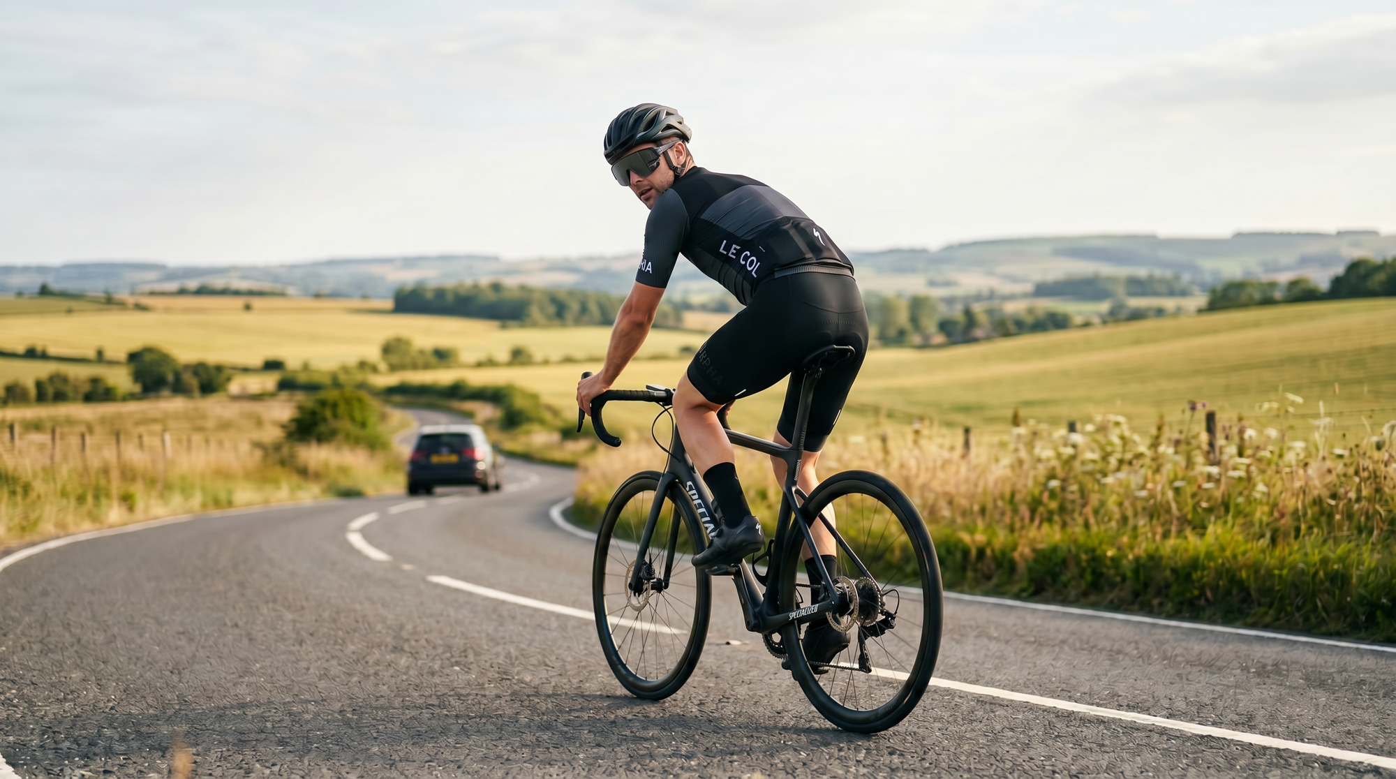 A road cyclist wearing TriEye The View, with a car approaching behind